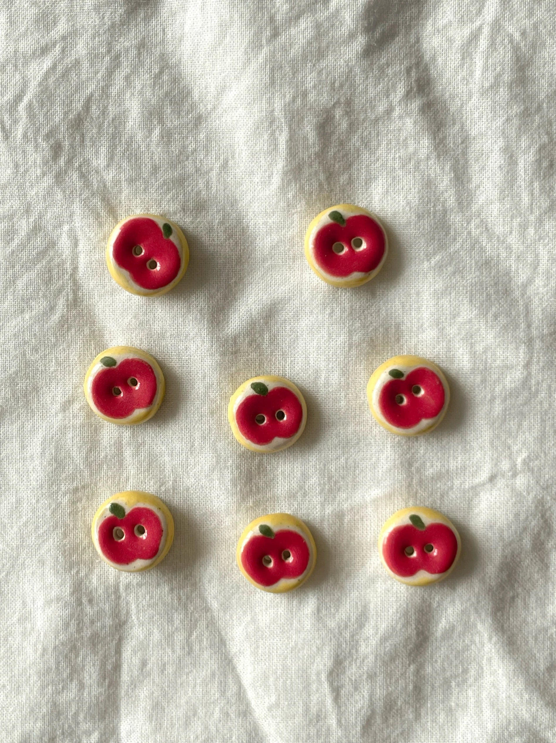 red apple buttons