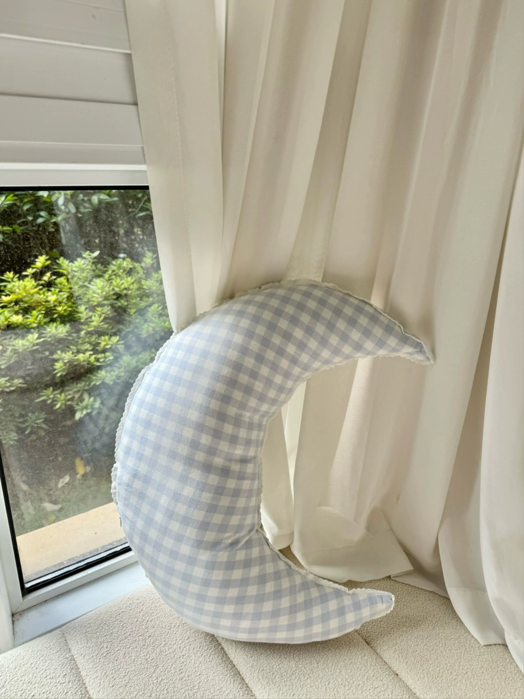 checked crescent moon pillow